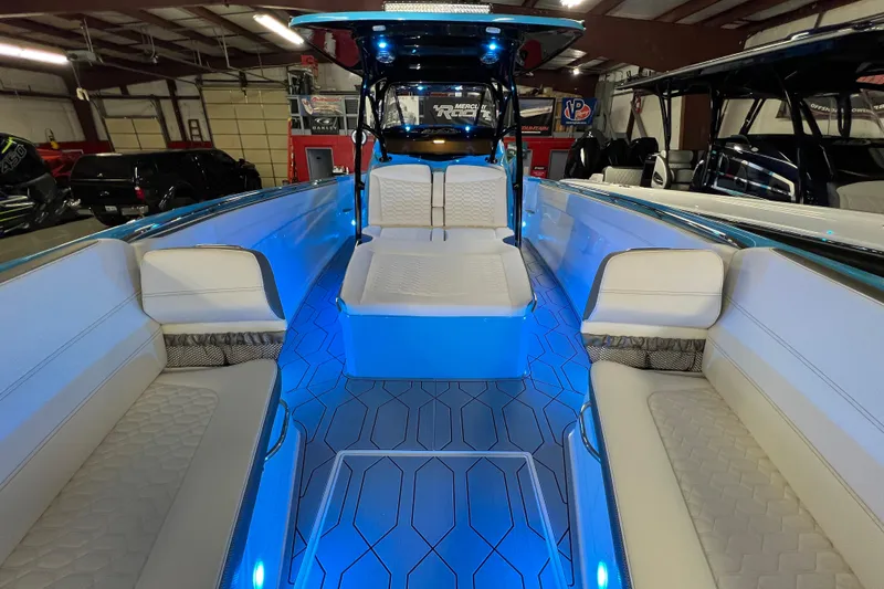 Slide: The Image of 2025 Nor-Tech 390 Sport Center Console with illuminated seating and modern interior design. - 13
