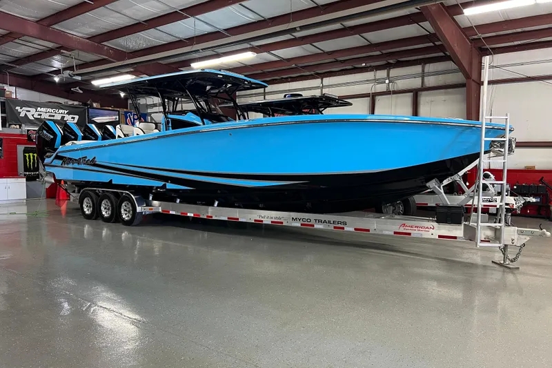 Slide: The Image of 2025 Nor-Tech 390 Sport Center Console boat on trailer in a showroom. - 3