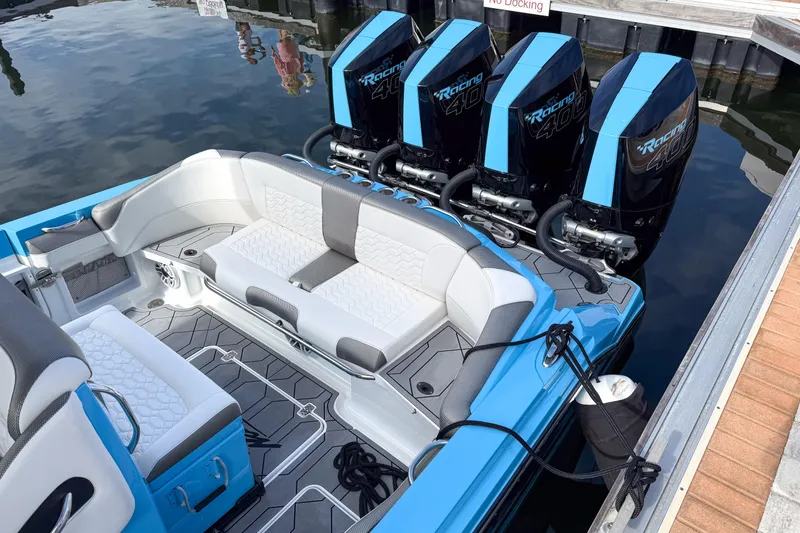Slide: The Image of 2025 Nor-Tech 390 Sport Center Console with quad engines, docked at marina. - 5