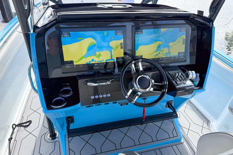 Slide: The Image of 2025 Nor-Tech 390 Sport Center Console with dual navigation screens and modern steering wheel. - 8