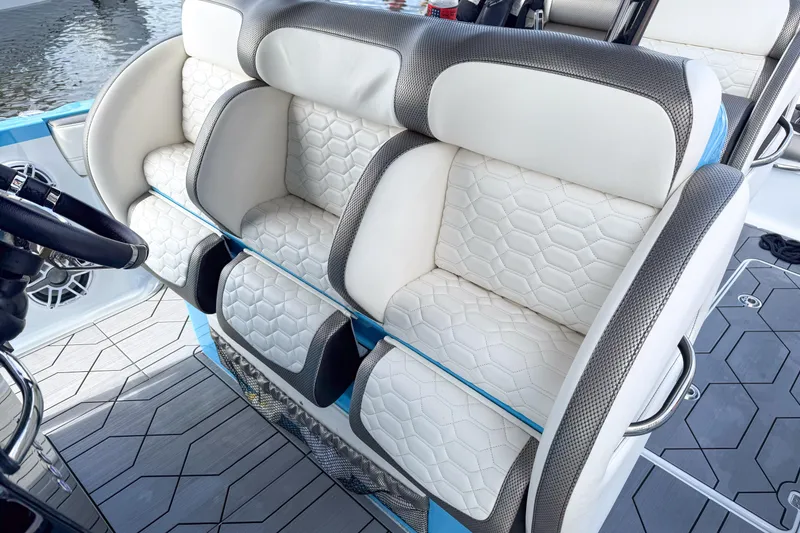 Slide: The Image of Luxurious seating on 2025 Nor-Tech 390 Sport Center Console boat, featuring stylish white upholstery. - 9