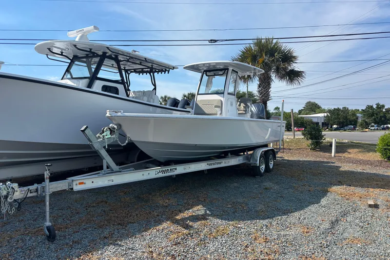 Slide: The Image of 2027 Sportsman Masters 247OE Bay Boat on trailer, parked outdoors. - 16