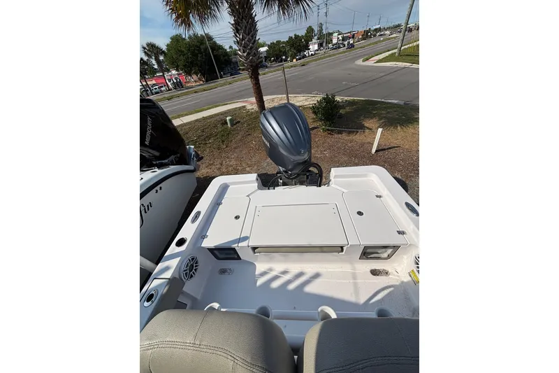 Slide: The Image of 2027 Sportsman Masters 247OE Bay Boat rear view with motor and seating. - 18