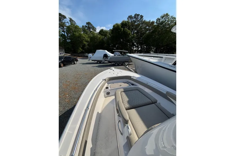 Slide: The Image of 2027 Sportsman Masters 247OE Bay Boat on display in a gravel lot. - 20