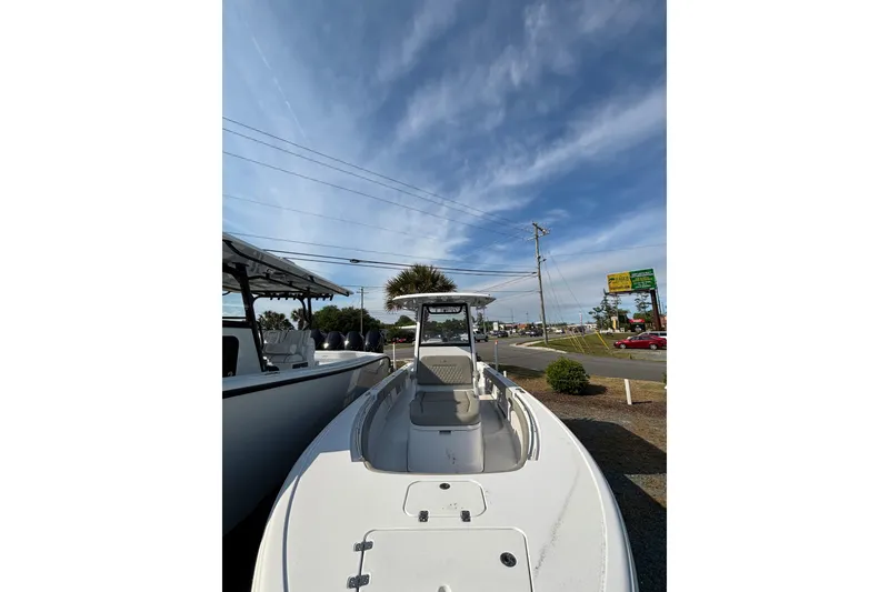Slide: The Image of 2027 Sportsman Masters 247OE Bay Boat under clear blue sky, parked near road. - 23