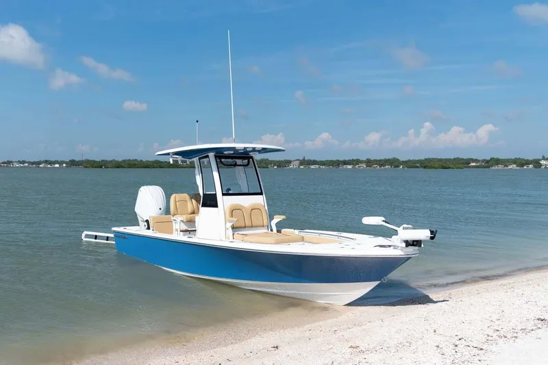 Slide: The Image of Manufacturer Provided Image: 2025 Sportsman Masters 247OE Bay Boat on sandy shore, calm waters, clear sky. - 4