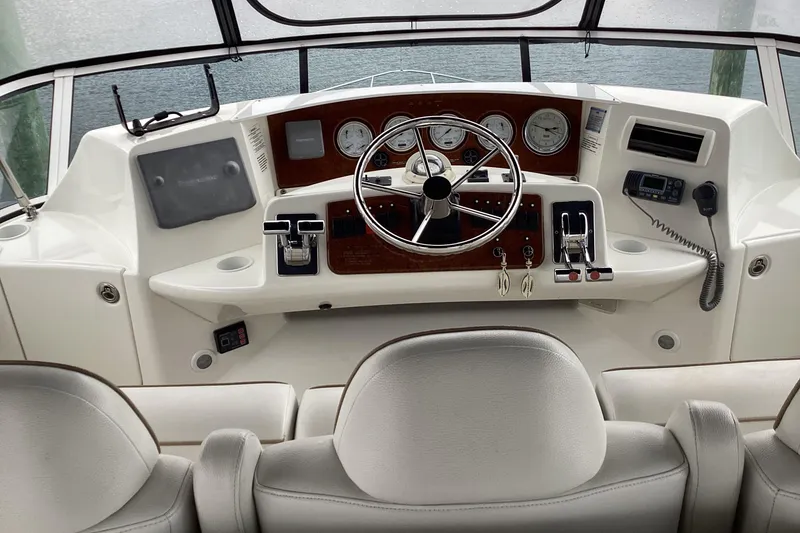 Slide: The Image of Close-up of 2006 Silverton 38 Sport Bridge tachometers on a wooden dashboard. - 10