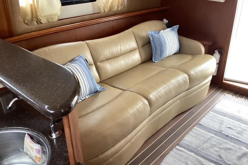 Slide: The Image of Luxurious interior of 2006 Silverton 38 Sport Bridge yacht with plush seating and wooden accents. - 18
