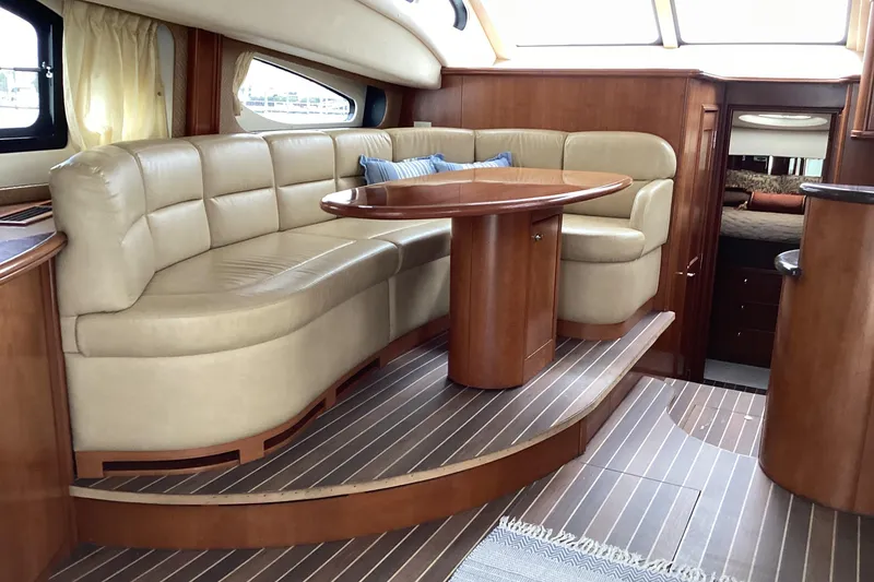 Slide: The Image of Interior of 2006 Silverton 38 Sport Bridge yacht with leather seating and wood accents. - 19