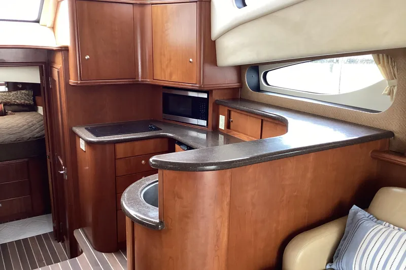 Slide: The Image of 2006 Silverton 38 Sport Bridge kitchen with wood cabinetry and modern fixtures. - 23