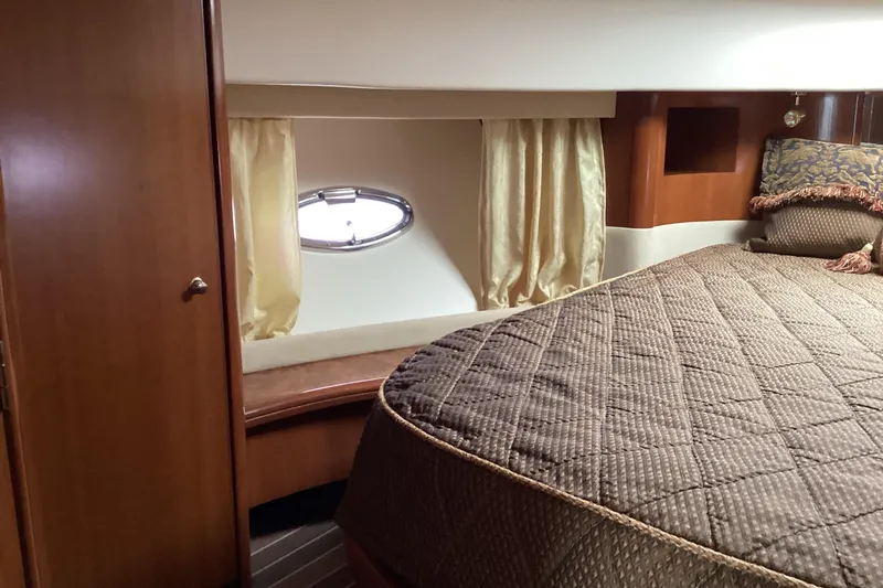 Slide: The Image of Bathroom interior of 2006 Silverton 38 Sport Bridge yacht, featuring shower and porthole window. - 31