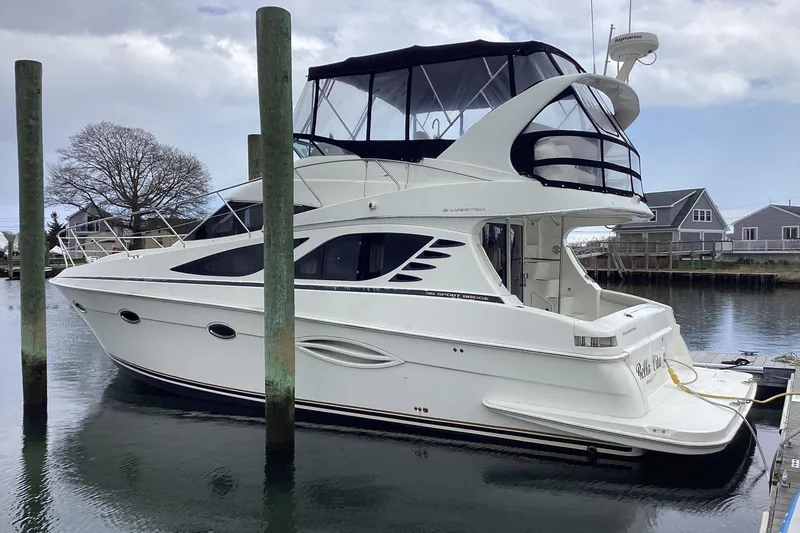 Slide: The Image of 2006 Silverton 38 Sport Bridge boat deck with carpeted flooring and storage compartments. - 5