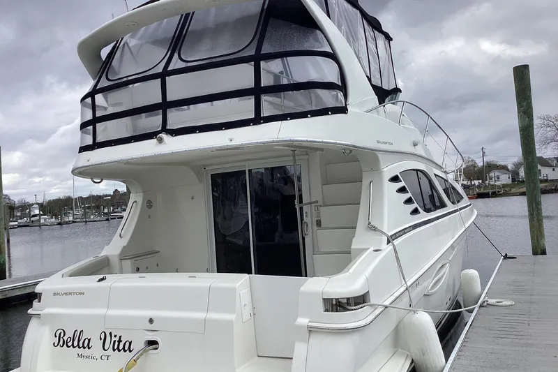 Slide: The Image of Luxurious interior of 2006 Silverton 38 Sport Bridge yacht with plush seating and "Relax" pillows. - 6