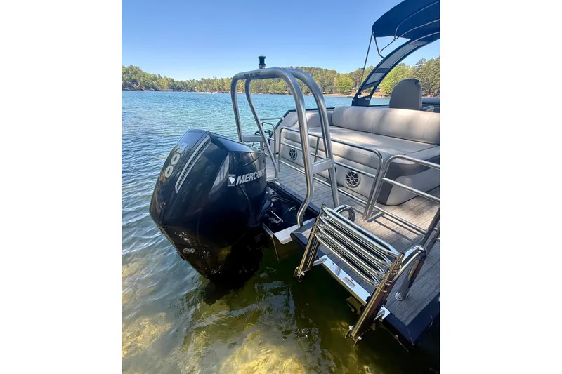Slide: The Image of 2022 Bentley Pontoons Elite 253 Swingback with Mercury engine on a serene lake. - 4