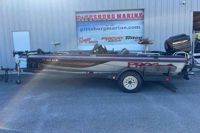 The Image of 1995 ProCraft V-180 boat on trailer outside Pittsburg Marine dealership. - 0