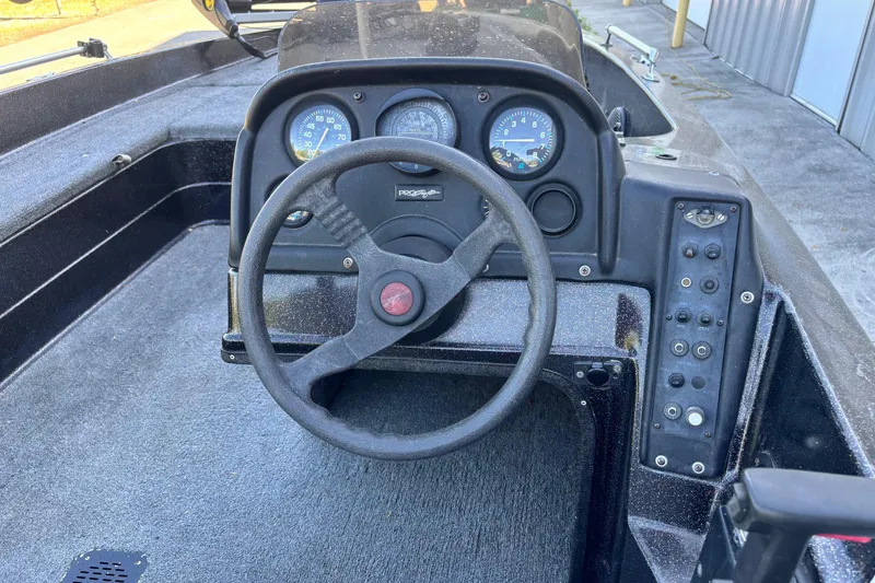 Slide: The Image of 1995 ProCraft V-180 boat dashboard with steering wheel and instrument panel. - 5