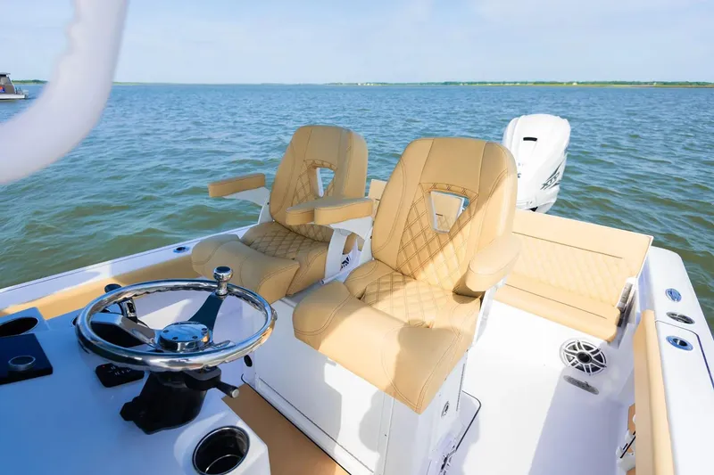 Slide: The Image of Manufacturer Provided Image: 2025 Sportsman Masters 267 Bay Boat interior with tan seats and steering wheel on open water. - 7