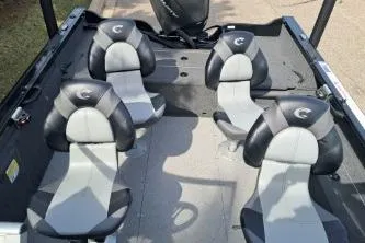Slide: The Image of 2019 Crestliner 1850 Fish Hawk WT interior with four seats and motor. - 12