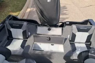 Slide: The Image of 2019 Crestliner 1850 Fish Hawk WT interior with seating and storage compartments. - 13