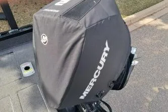 Slide: The Image of 2019 Crestliner 1850 Fish Hawk WT with Mercury engine cover, parked on pavement. - 16