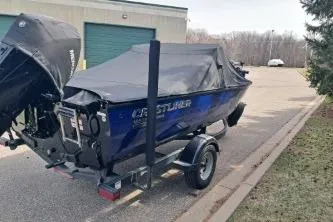 Slide: The Image of 2019 Crestliner 1850 Fish Hawk WT boat on trailer, covered and parked outdoors. - 4