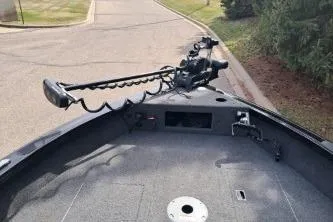 Slide: The Image of 2019 Crestliner 1850 Fish Hawk WT boat with trolling motor on a paved road. - 7