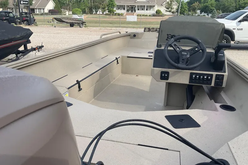 Slide: The Image of 2026 Excel 1751 River Warrior SC boat interior with steering console and seating. - 3