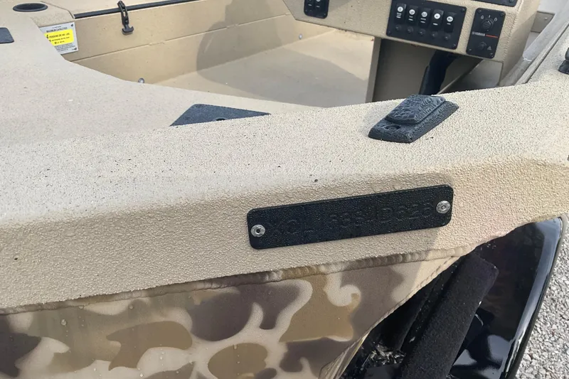 Slide: The Image of 2026 Excel 1751 River Warrior SC boat interior with control panel and camouflage design. - 5