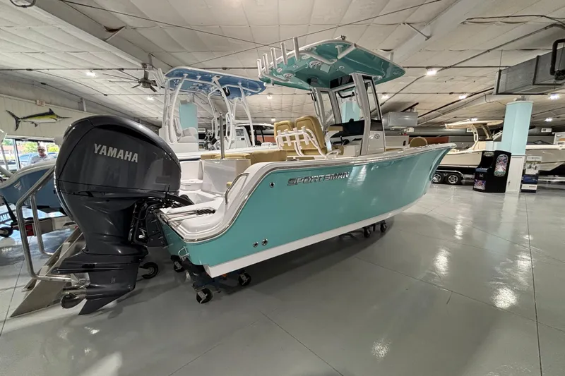 Slide: The Image of 2027 Sportsman Heritage 231 Center Console boat with Yamaha engine in showroom. - 12