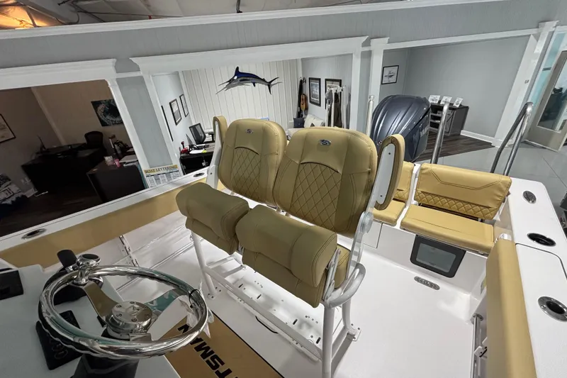 Slide: The Image of 2027 Sportsman Heritage 231 Center Console boat interior with tan seating and steering wheel. - 13