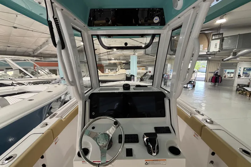 Slide: The Image of Interior view of 2027 Sportsman Heritage 231 Center Console boat in showroom. - 14