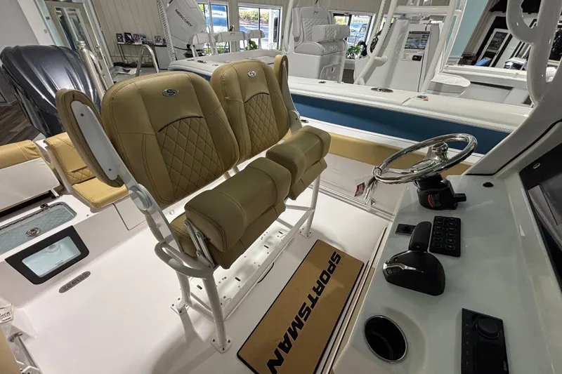 Slide: The Image of 2027 Sportsman Heritage 231 Center Console boat interior with tan seating and steering console. - 15