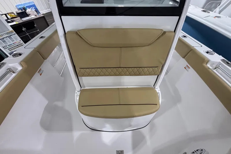 Slide: The Image of 2027 Sportsman Heritage 231 Center Console boat with tan cushioned seating. - 17
