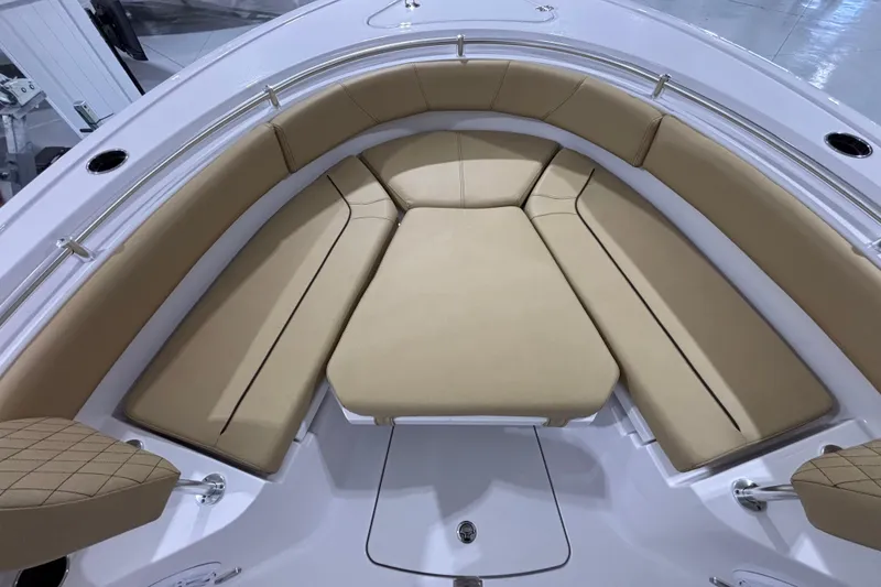 Slide: The Image of 2027 Sportsman Heritage 231 Center Console boat with tan cushioned seating area. - 18