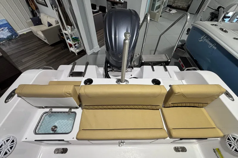 Slide: The Image of 2027 Sportsman Heritage 231 Center Console boat interior with tan seating and engine view. - 20