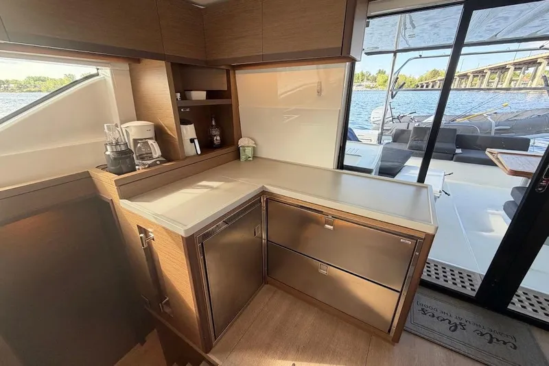 Slide: The Image of Modern kitchen area on a 2021 Lagoon 50 yacht with outdoor view. - 10