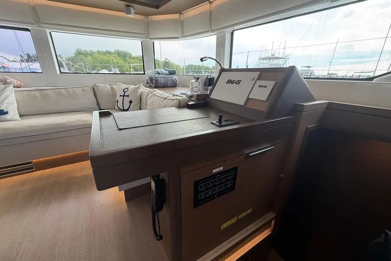 Slide: The Image of Interior of 2021 Lagoon 50 yacht with navigation station and cozy seating area. - 12