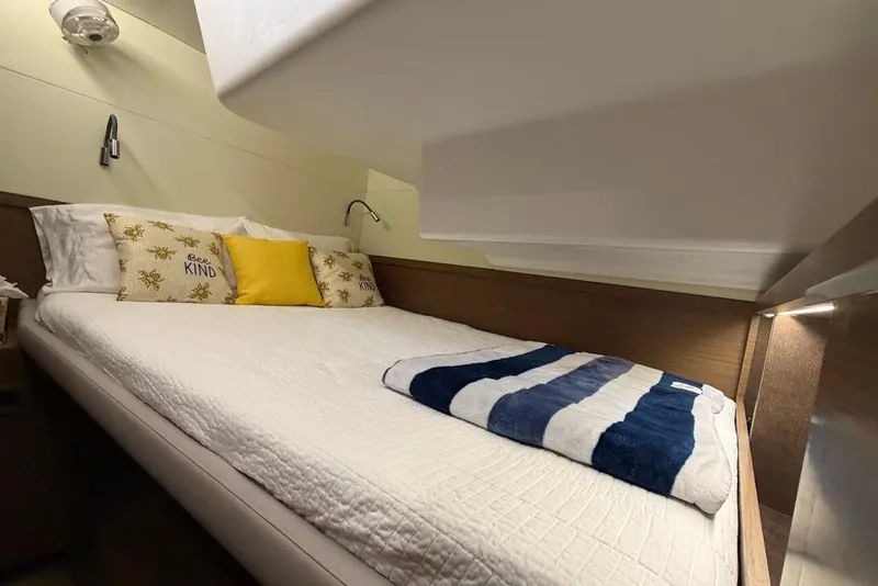 Slide: The Image of Cozy cabin interior of 2021 Lagoon 50 yacht with comfortable bedding and decorative pillows. - 15