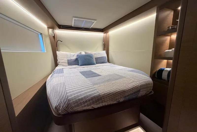 Slide: The Image of Luxurious bedroom interior of 2021 Lagoon 50 yacht with modern design and cozy bedding. - 16