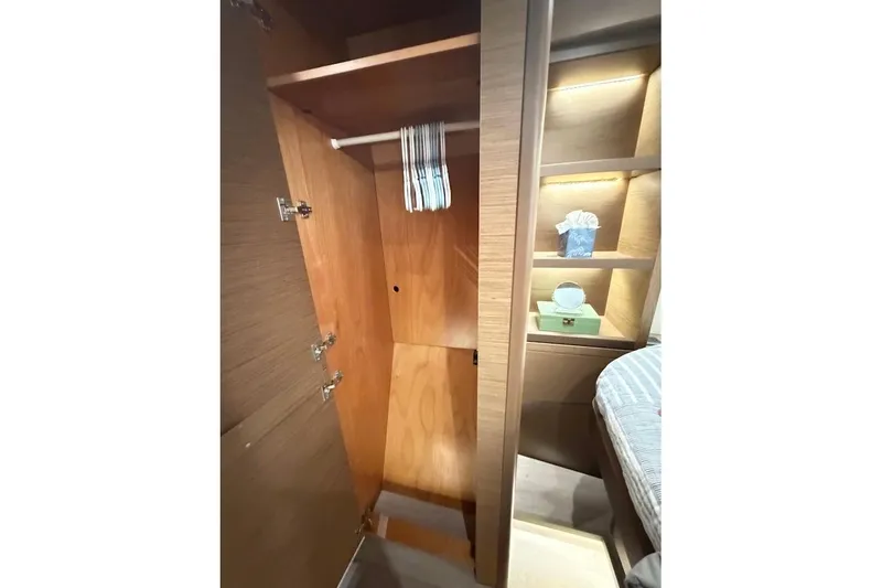 Slide: The Image of Wooden wardrobe and shelves in a 2021 Lagoon 50 yacht interior. - 22