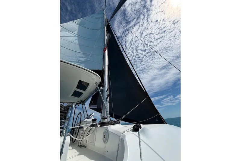 Slide: The Image of Sailing on a 2021 Lagoon 50 catamaran under a partly cloudy sky. - 3