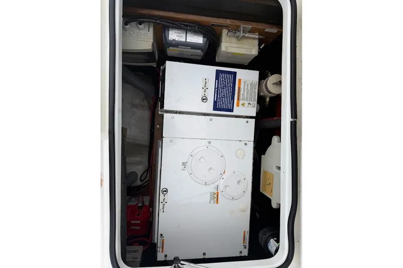 Slide: The Image of Engine compartment of a 2021 Lagoon 50 catamaran, showcasing mechanical components and wiring. - 31