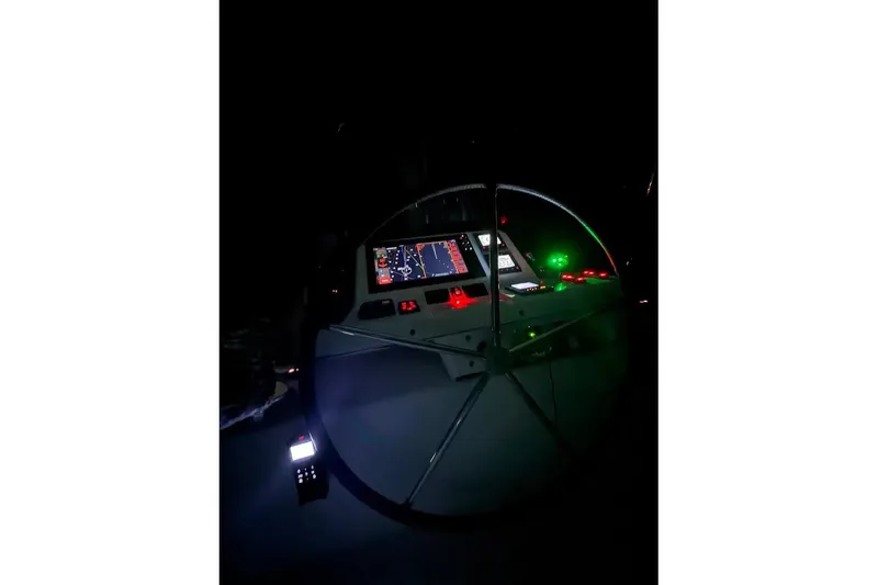 Slide: The Image of Cockpit of 2021 Lagoon 50 yacht illuminated at night with navigation instruments. - 4