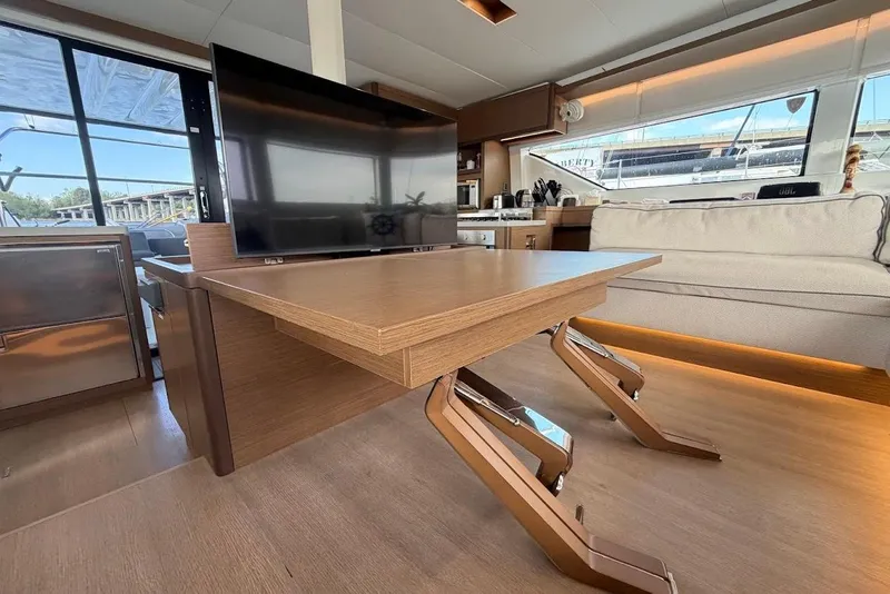 Slide: The Image of Interior of 2021 Lagoon 50 yacht with modern furnishings and large windows. - 9