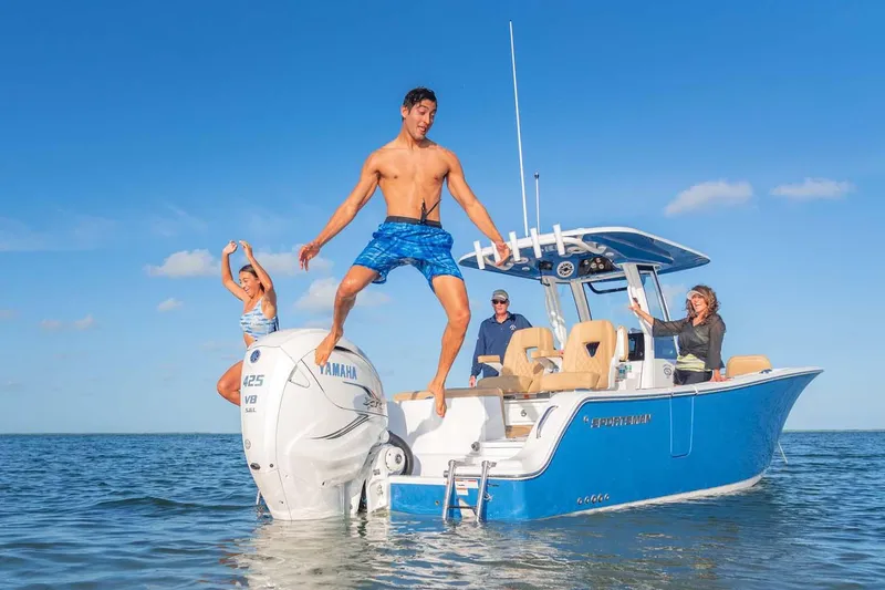 Slide: The Image of Manufacturer Provided Image: 2025 Sportsman Heritage 261 Center Console boat with people enjoying water activities. - 2