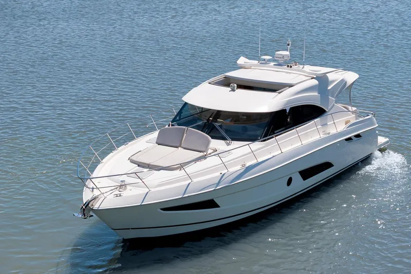 The Image of 2020 Riviera 4800 Sport Yacht cruising on calm blue waters. - 0