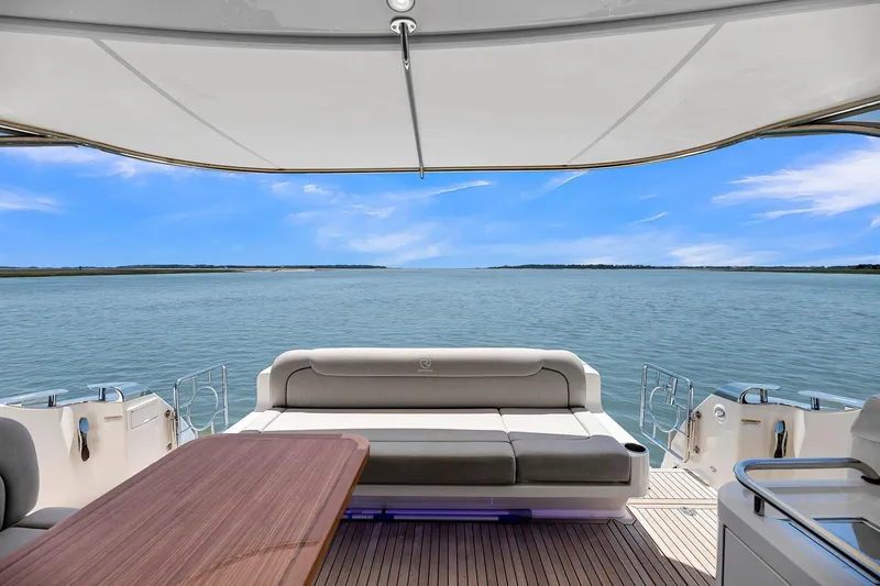 Slide: The Image of 2020 Riviera 4800 Sport Yacht with luxurious seating and ocean view. - 22