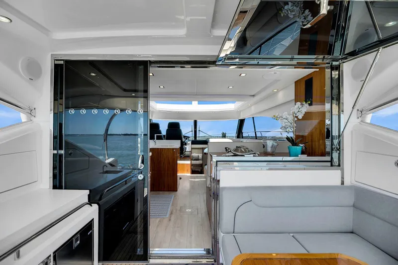 Slide: The Image of Interior of 2020 Riviera 4800 Sport Yacht with modern design and luxurious seating. - 26