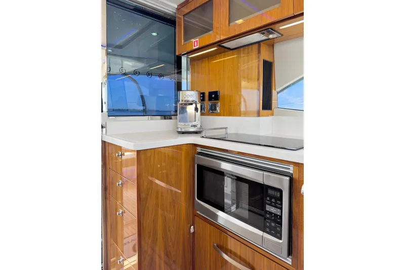 Slide: The Image of Luxurious kitchen area in 2020 Riviera 4800 Sport Yacht with modern appliances. - 44