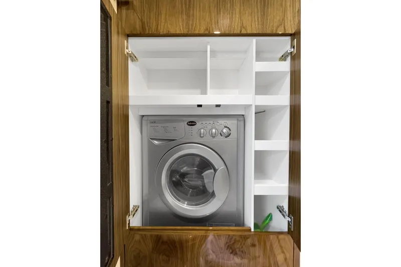 Slide: The Image of Washing machine in wooden cabinet on 2020 Riviera 4800 Sport Yacht. - 53